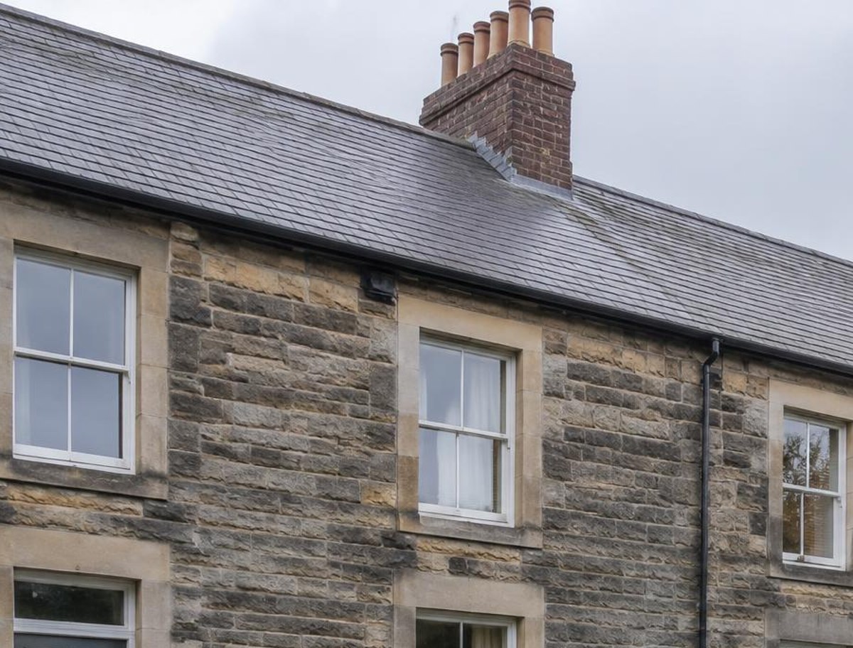 Slate roof and chimney stacks on a stone-built terrace